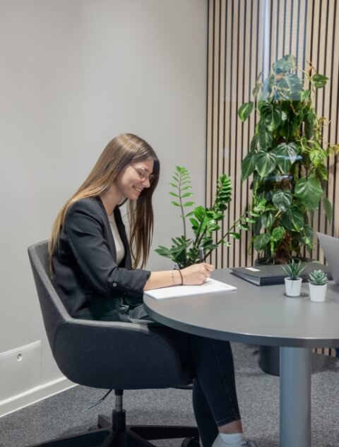 Young woman taking notes during a conversation