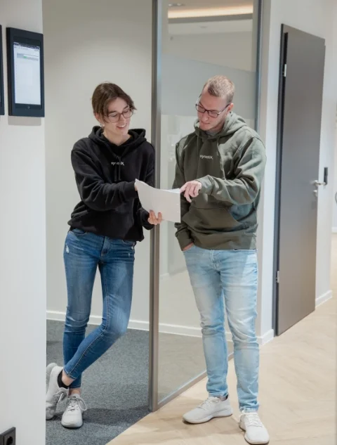 Your benefits Colleagues look at documents at the door