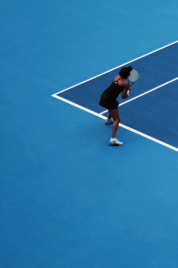 Female tennis player on a blue court